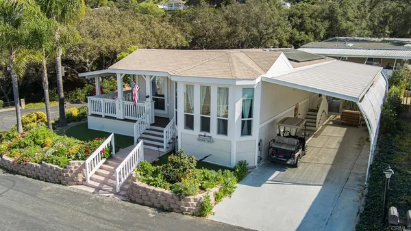 an aerial view of a house with a yard garden and patio