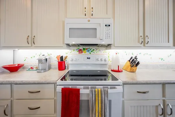 a kitchen with cabinets and a refrigerator