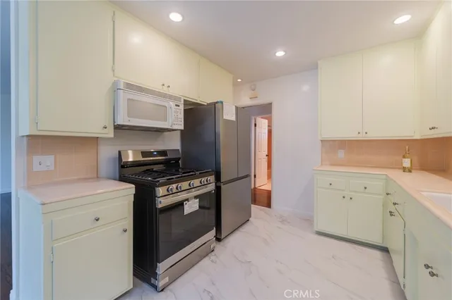 a kitchen with a stove sink and refrigerator