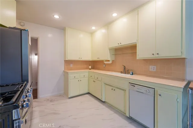 a kitchen with a sink appliances and cabinets
