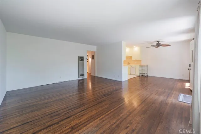 a view of empty room with wooden floor