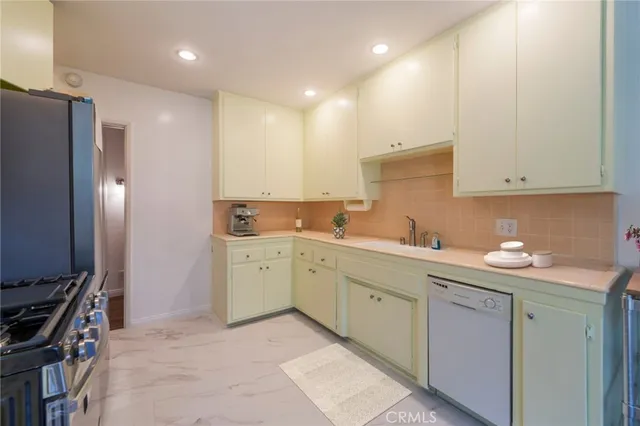 a kitchen with a sink stove and cabinets