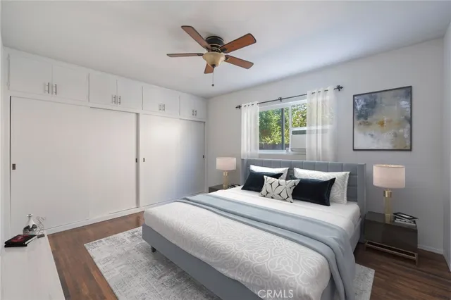 a bedroom with a large bed and a ceiling fan