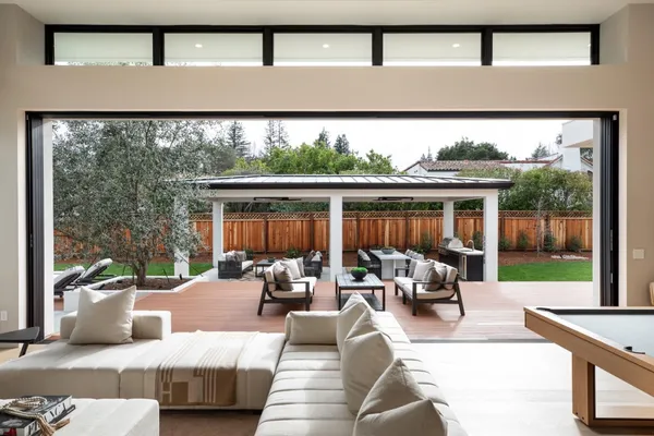 a living room with furniture and a floor to ceiling window