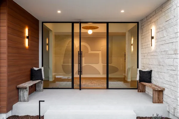 a living room with furniture a fireplace and a large window