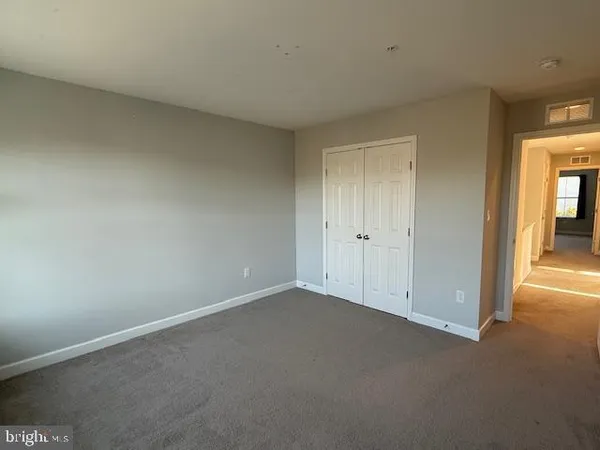 a view of a hallway with wooden shelves