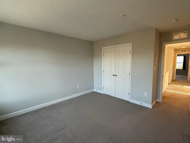 a view of a hallway with wooden shelves