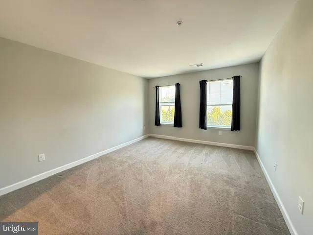 an empty room with closet area
