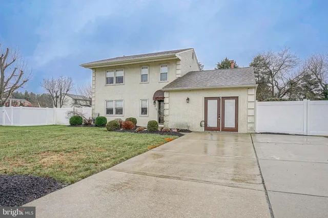 a view of a white house with a yard