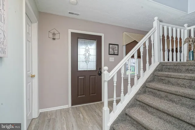 a view of staircase with wooden floor and a window
