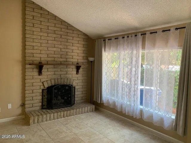 a view of an empty room with a fireplace