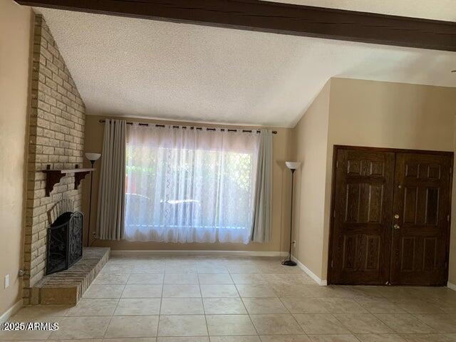 1514 East Weathervane Lane Tempe, AZ 85283 - Photo 14 of 18 a view of an empty room with a fireplace