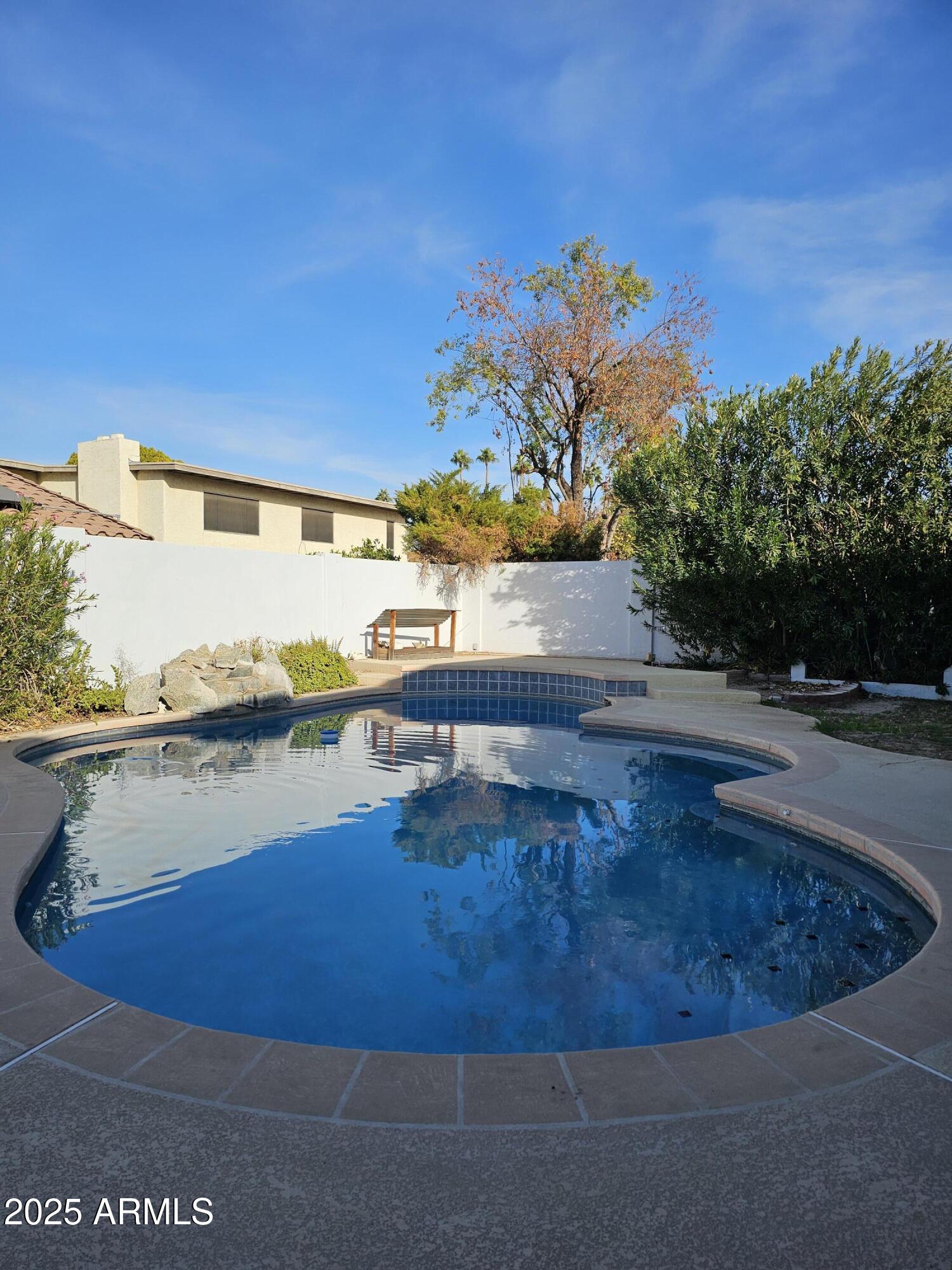 1514 East Weathervane Lane Tempe, AZ 85283 - Photo 2 of 18 a view of a swimming pool with an ocean view