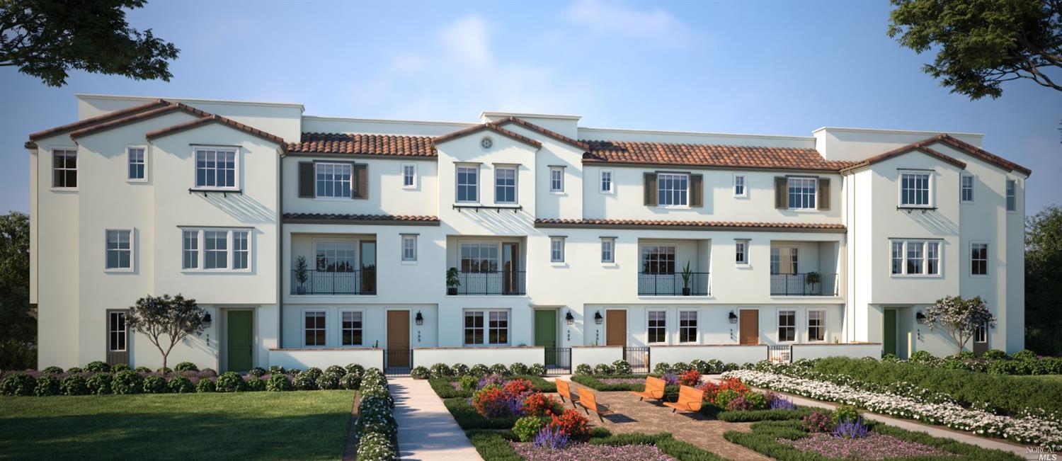 a front view of a residential houses with yard and green space