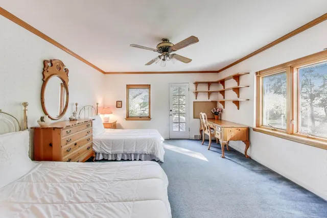 a bedroom with furniture and a large window