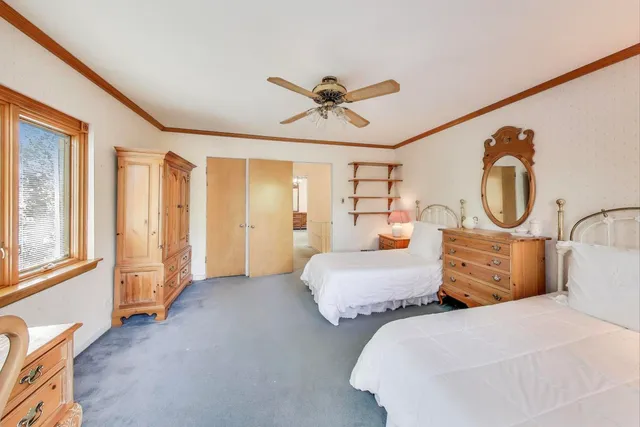 a bedroom with bed and window