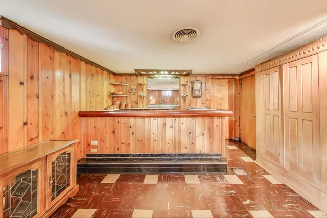 a room with lots of wooden furniture and a large window