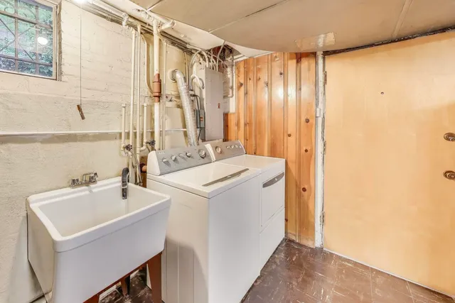 a view of a patio with chairs and table under an umbrella