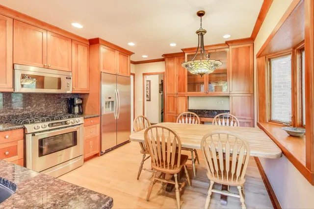 a kitchen with stainless steel appliances granite countertop a stove a sink dishwasher and a refrigerator