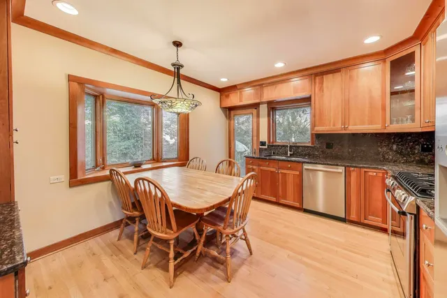 a kitchen with a table chairs sink and cabinets
