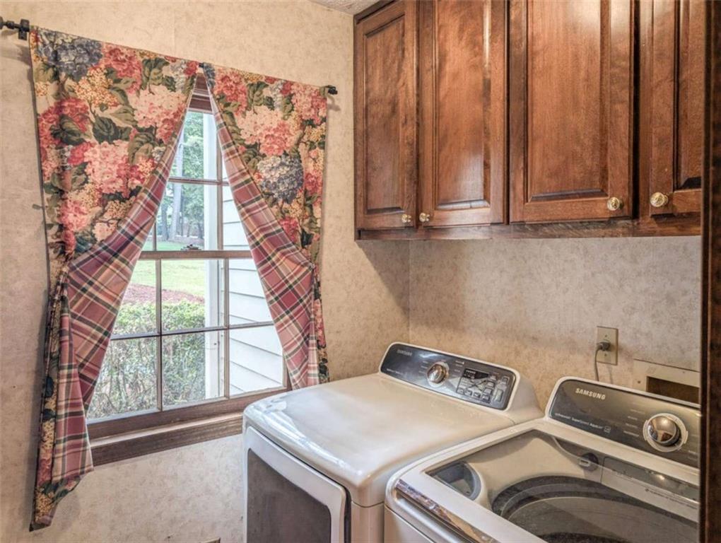 3838 Hunting Ridge Drive Southwest Lilburn, GA 30047 - Photo 24 of 56 a utility room with dryer and washer