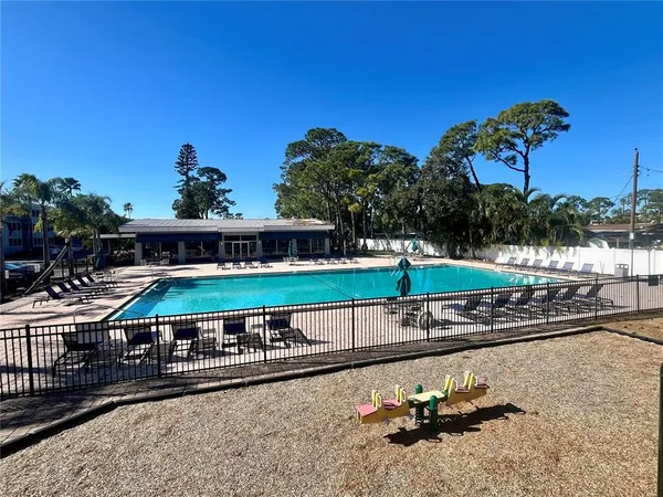 a swimming pool with outdoor seating
