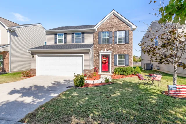a front view of a house with a yard and garage
