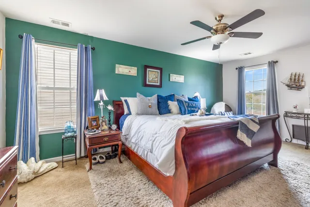 a bed room with a bed and a chair