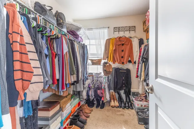 a view of walk in closet with clothes