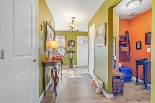 a view of a hallway and a livingroom with furniture