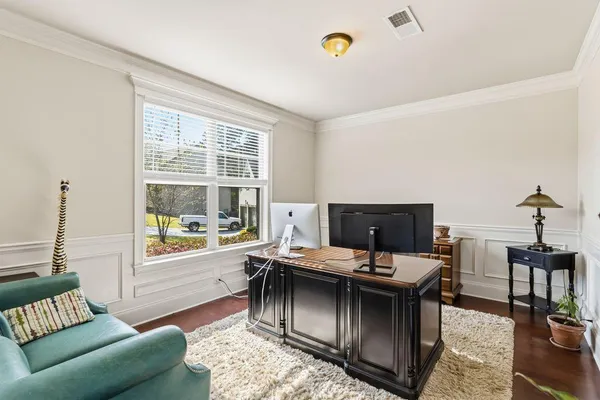 a kitchen with granite countertop a table chairs stove a refrigerator and wooden floor