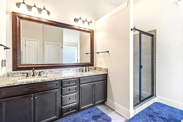 a bathroom with a tub shower and a sink
