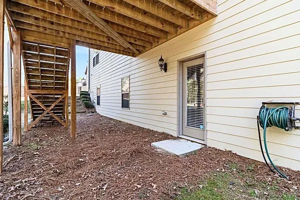 a view of a porch with wooden floor and floor to ceiling window