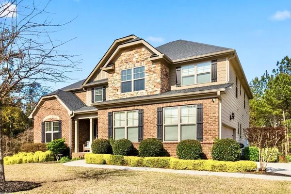 a front view of a house with a yard table and chairs