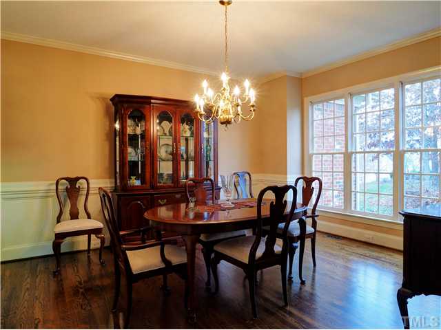 5528 Overleaf Court Raleigh, NC 27615 - Photo 11 of 25 a view of a dining room with furniture a chandelier and wooden floor