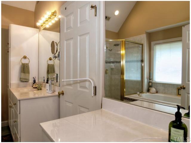 5528 Overleaf Court Raleigh, NC 27615 - Photo 17 of 25 a bathroom with a tub sink and mirror