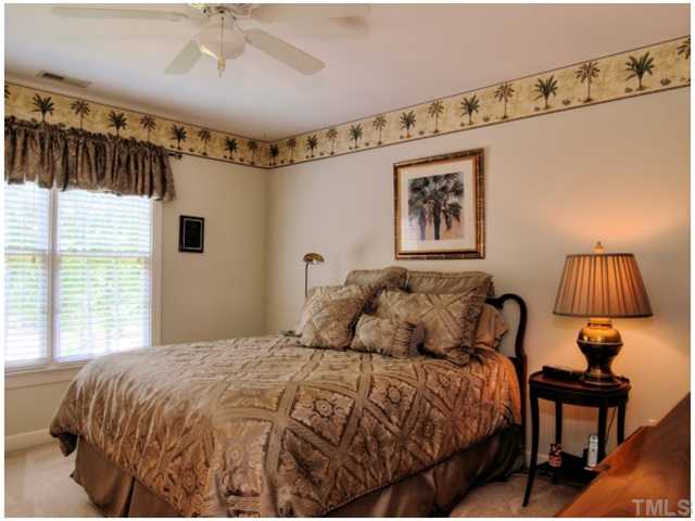 5528 Overleaf Court Raleigh, NC 27615 - Photo 18 of 25 a bedroom with a bed and a painting on the wall