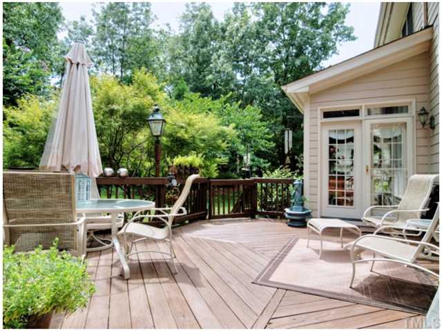 5528 Overleaf Court Raleigh, NC 27615 - Photo 22 of 25 a view of backyard with a table and chairs with wooden floor and fence