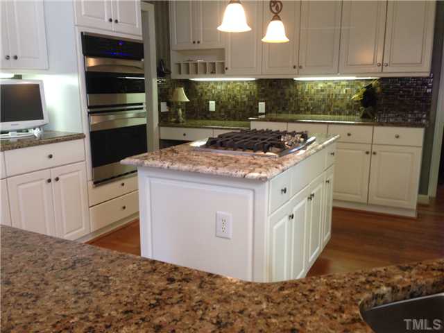 5528 Overleaf Court Raleigh, NC 27615 - Photo 3 of 25 a kitchen with white cabinets and appliances