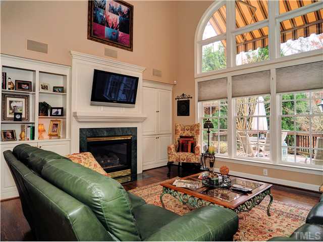 5528 Overleaf Court Raleigh, NC 27615 - Photo 10 of 25 a living room with furniture a flat screen tv and a fireplace
