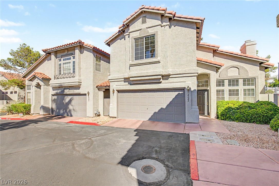 2223 Ramsgate Drive Henderson, NV 89074 - Photo 2 of 32 A well-maintained facade with stucco siding, tile roofing, and integrated garages welcomes residents and guests.