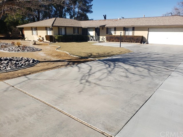 14972 Tacony Road Apple Valley, CA 92307 - Photo 1 of 1 a front view of a house with a yard