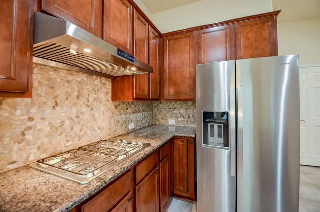 a kitchen with sink and mirror