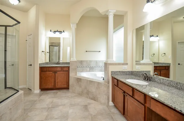 a bathroom with a shower and a sink