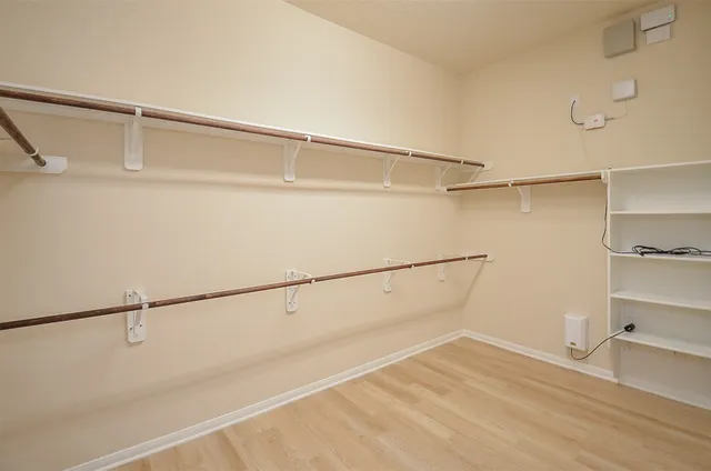 a bathroom with a granite countertop double vanity sink mirror and a bathtub