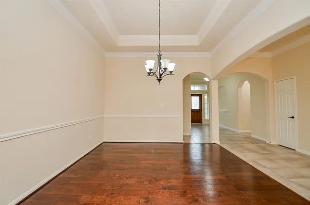 a view of a room with wooden floor and white walls