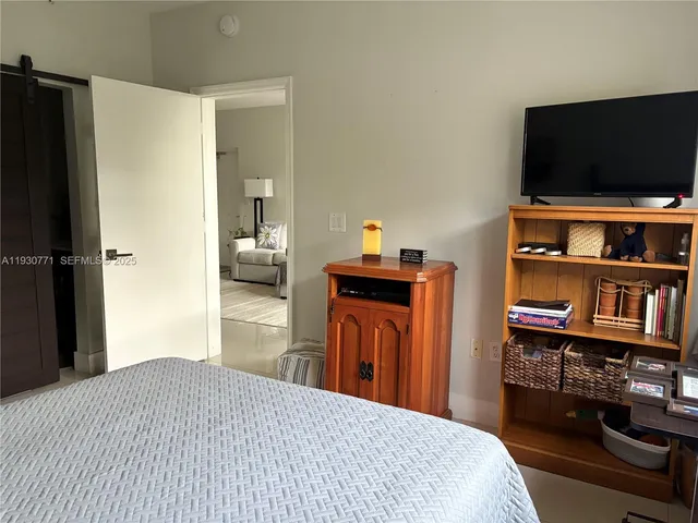 a bedroom with a bed and a television in it