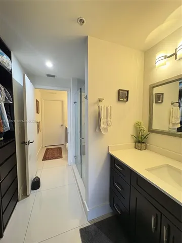 a bathroom with a sink a toilet and a shower
