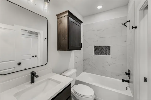 a bathroom with a sink toilet a tub and shower