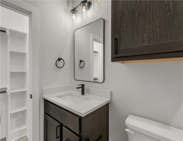 a bathroom with a sink a toilet and mirror